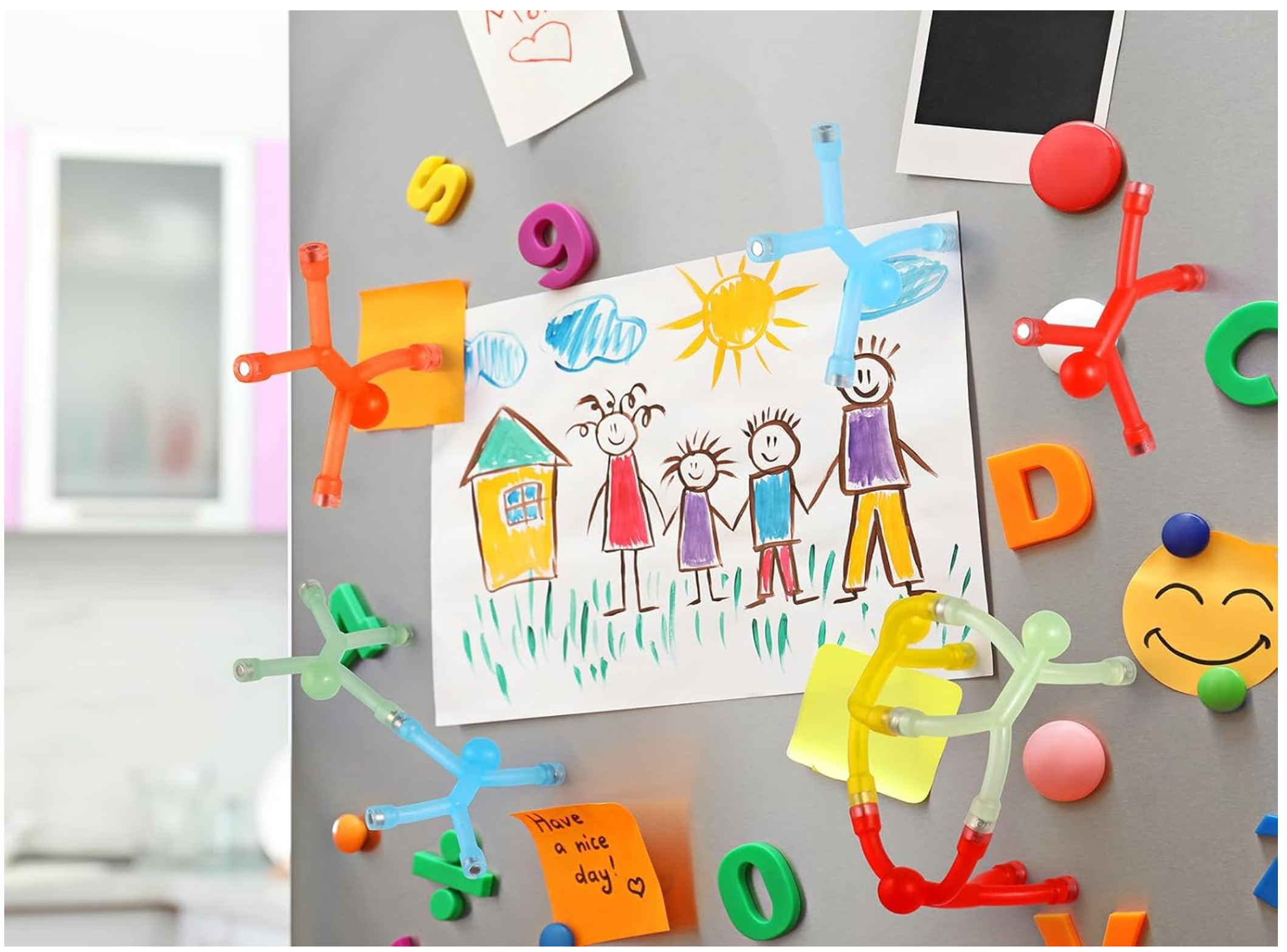 Colorful magnetic people holding classroom artwork on a magnetic board
